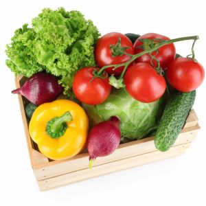 Fresh vegetables in wooden box on white background
