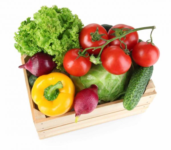 Fresh vegetables in wooden box on white background
