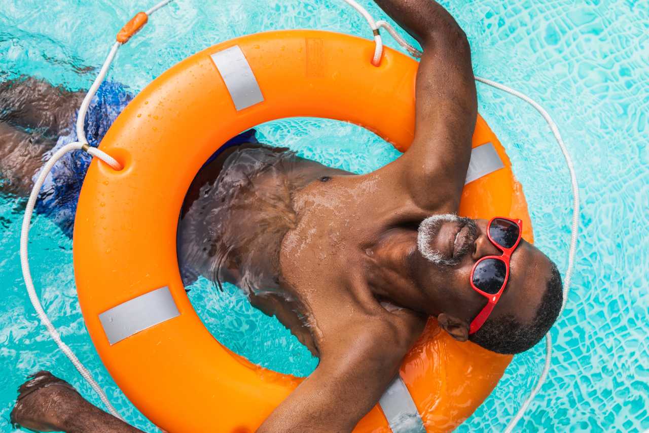 Happy senior man at the swimming pool