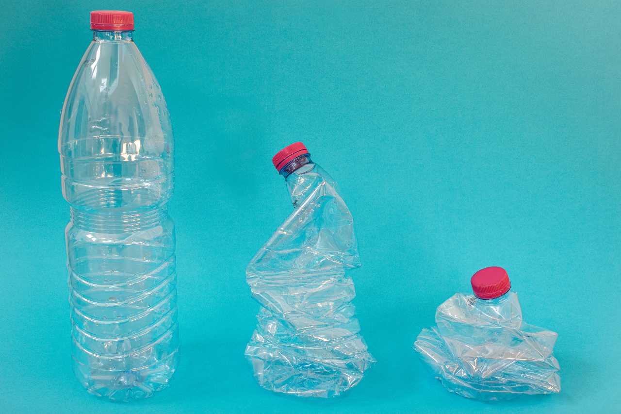 Plastic water bottles crushed and pressed for recycling, recycle concept, less volume